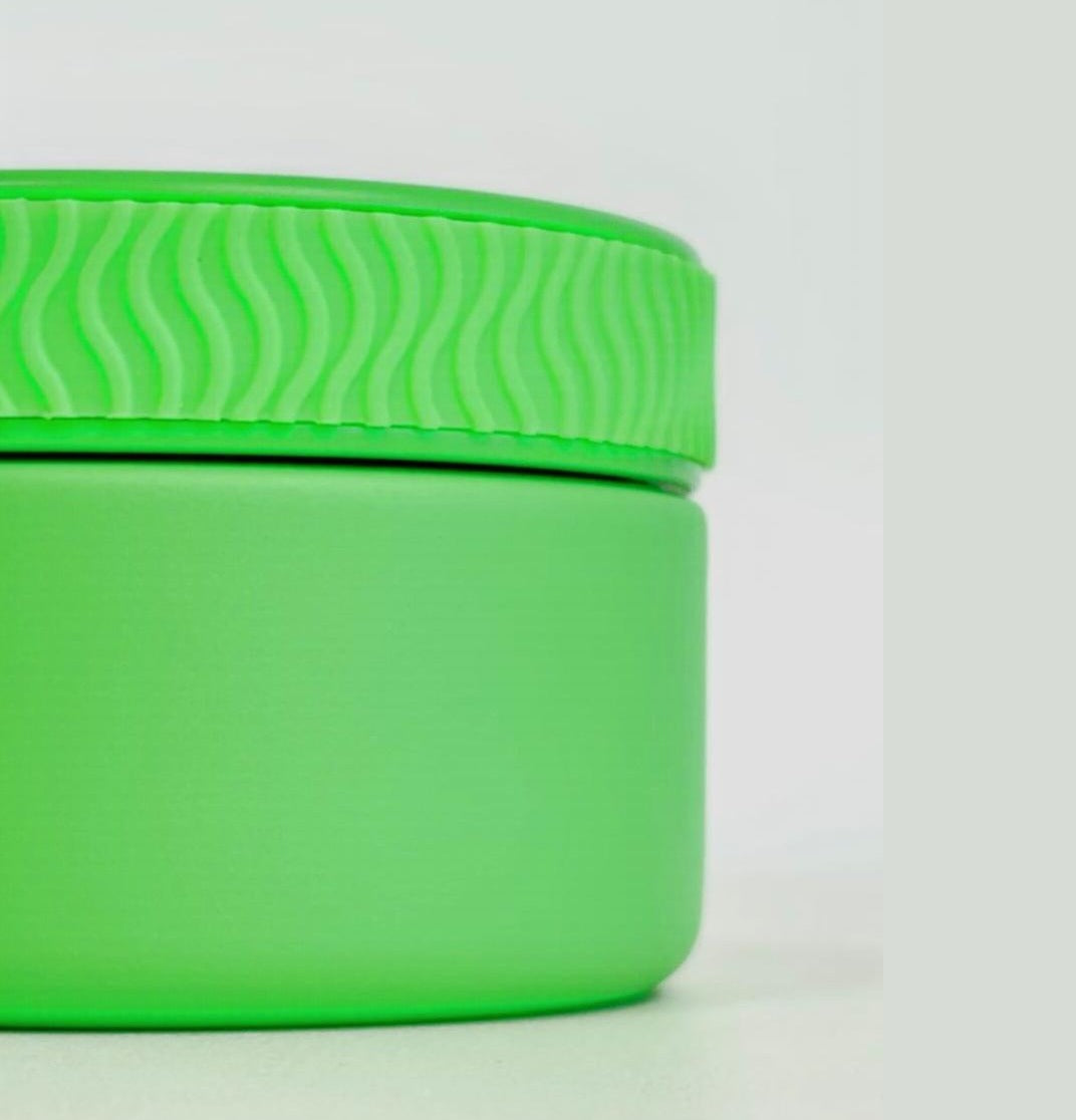 Green container with lid on a white background