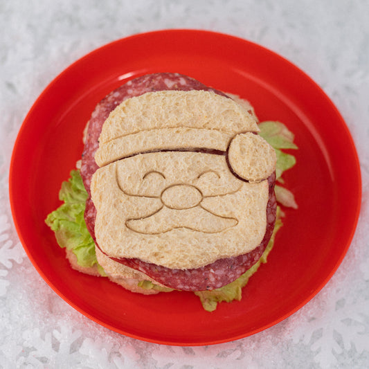 Christmas‑themed sandwiches shaped like Santa and Christmas trees made using the Lunch Punch Christmas cutters