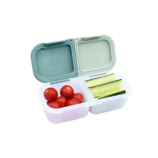 Bento box with compartments containing tomatoes and cucumbers on a white background