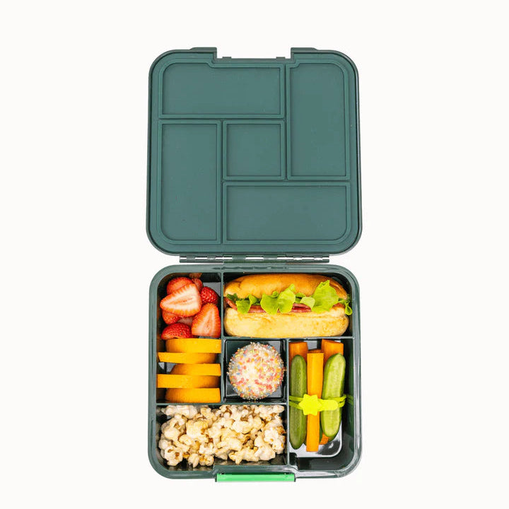 Top-down view of the open dark green MontiiCo Bento 5 lunch box packed with a burger, fruit, and snacks across its five compartments