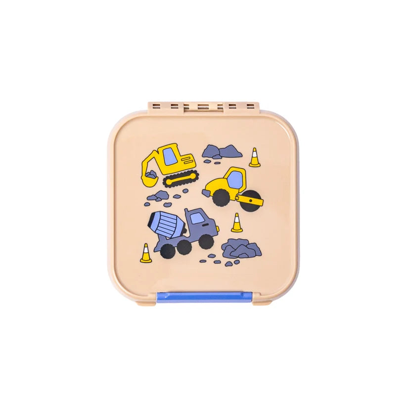 Top-down view of the closed beige MontiiCo Bento 2 snack box featuring a construction vehicle print with an excavator, steamroller, and cement mixer.