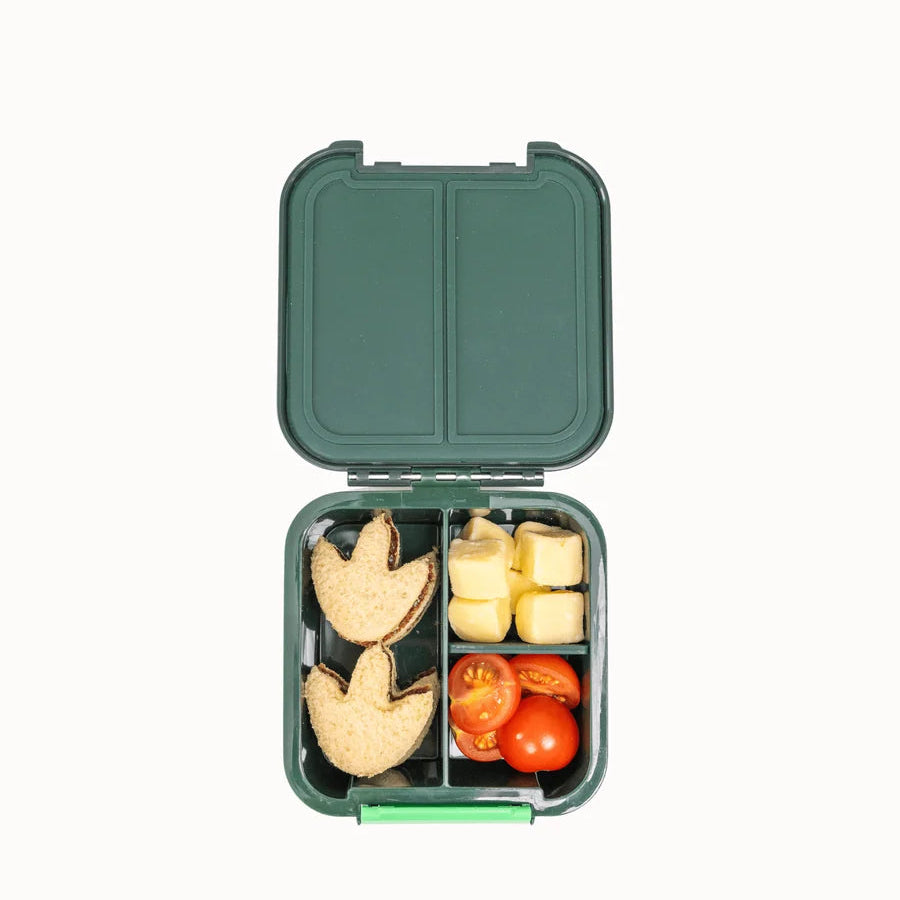 Open MontiiCo Bento 2 Dinosaur snack box packed with snacks, including footprint-shaped biscuits, cheese, and cherry tomatoes.