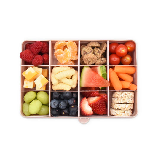 Pink 12‑compartment Melii Snackle Box with removable dividers for custom snack layouts.