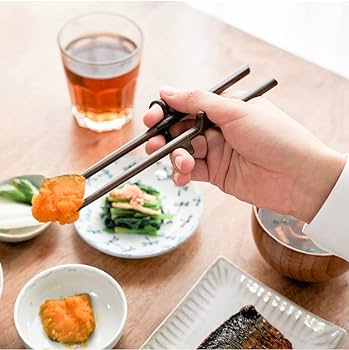 left handed adult training chopsticks positioned through the loops to show proper technique