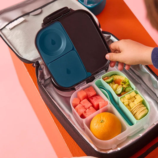 b.box Silicone Bento Tray : MINI - Forest Bento box with compartments filled with fruits and vegetables on a colorful background