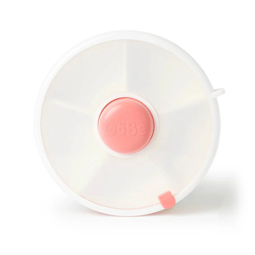 A coral pink GoBe snack spinner with a clear lid and a central button to rotate between different snacks.