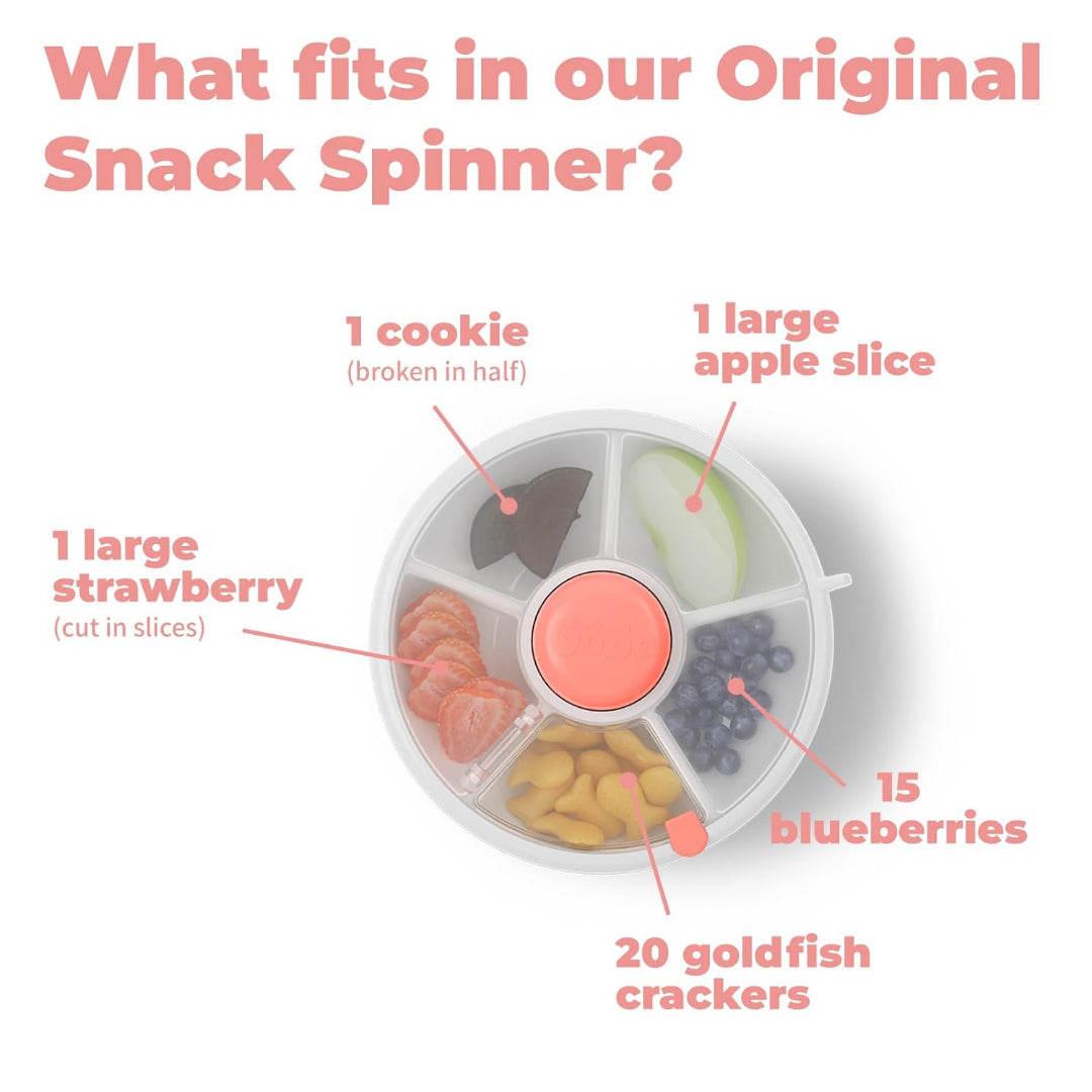 op‑down view of the GoBe Original Snack Spinner showing five compartments filled with sample portions: half a cookie, a large apple slice, 15 blueberries, 20 goldfish‑style crackers, and sliced strawberry