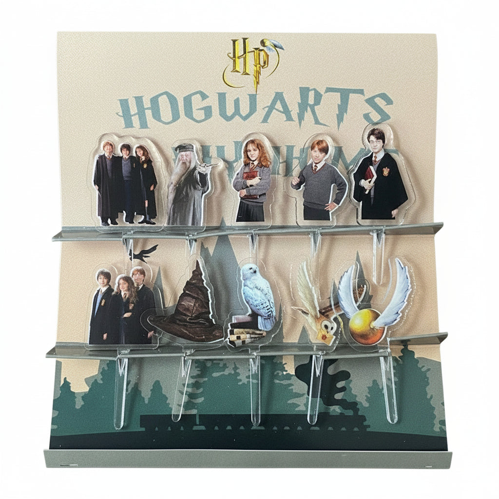 Pack of acrylic food picks featuring characters and items from the Harry Potter Hogwarts series, displayed in a packaging that includes the Hogwarts crest and characters like Harry, Ron, and Hermione.