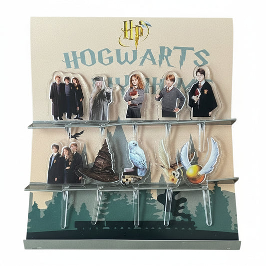 Pack of acrylic food picks featuring characters and items from the Harry Potter Hogwarts series, displayed in a packaging that includes the Hogwarts crest and characters like Harry, Ron, and Hermione.