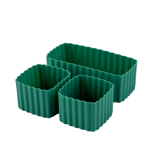 Two green silicone bento cups, one rectangular and one square, designed for holding food portions.