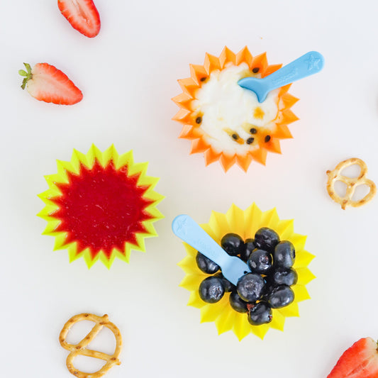 Colourful jumbo silicone snack cups used as bento cups to separate fruit and snacks in a lunchbox
