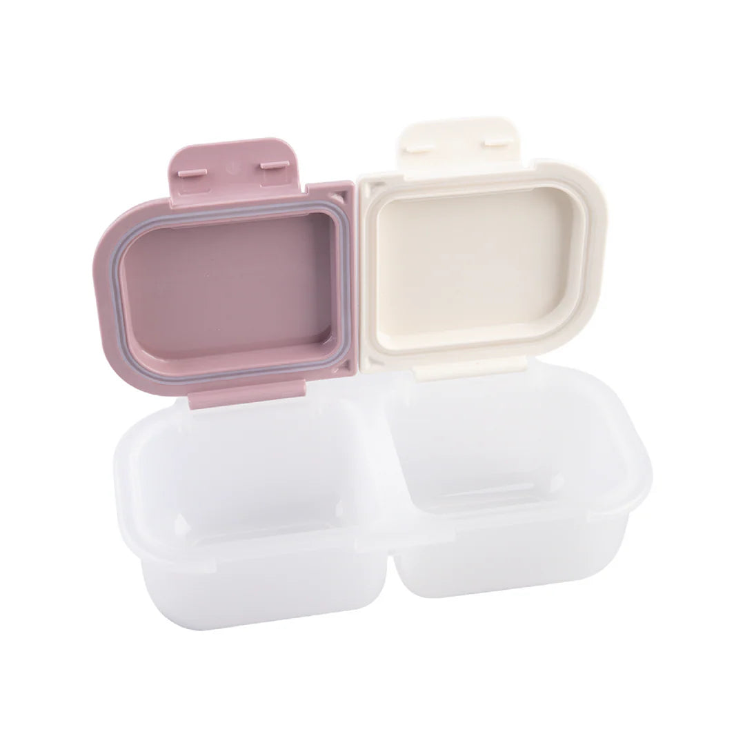 Two biodegradable food containers with pink and beige lids on a white background