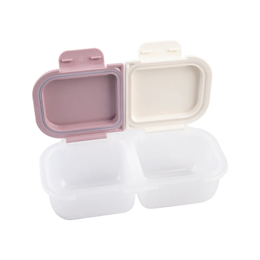 Two biodegradable food containers with pink and beige lids on a white background