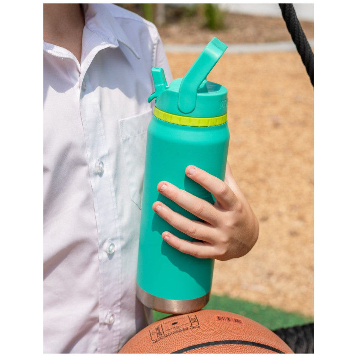 Person holding a Mojito MontiiCo 750ml Sport Drink water bottle with a straw lid outdoors