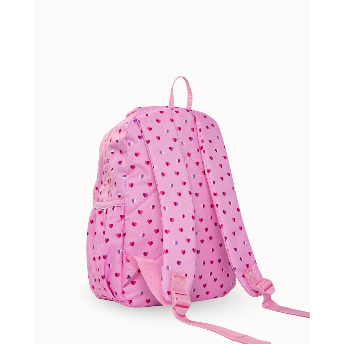 Side on view of MontiiCo Mini Backpack - Sweetheart Pink backpack with heart patterns on a white background