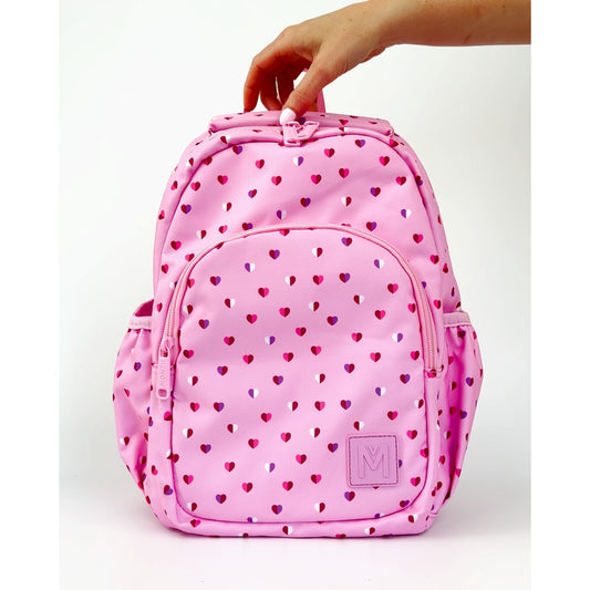 MontiiCo Mini Backpack - Sweetheart with heart pattern held by a hand on a white background