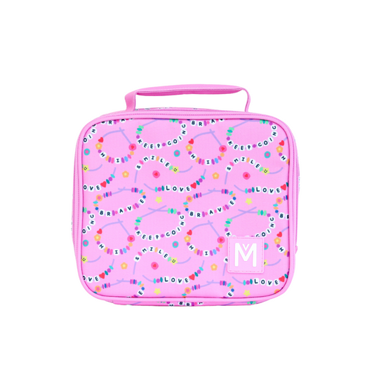 A friends forever pink lunchbag  decorated with colourful friendship‑bracelet‑style bead designs featuring positive words like “KEEP GOING,” “BRAVE,” “LOVE,” “SMILE,” and “KIND,” with a pink handle and a square patch displaying a white “Montiico” logo.