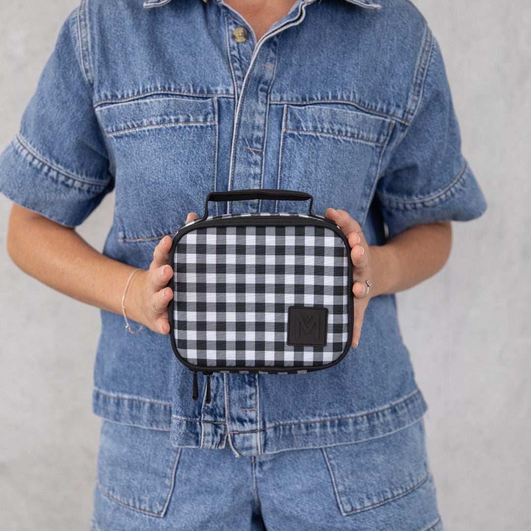 montiico mini gingham lunch bag shown being held to demonstrate compact size and portability