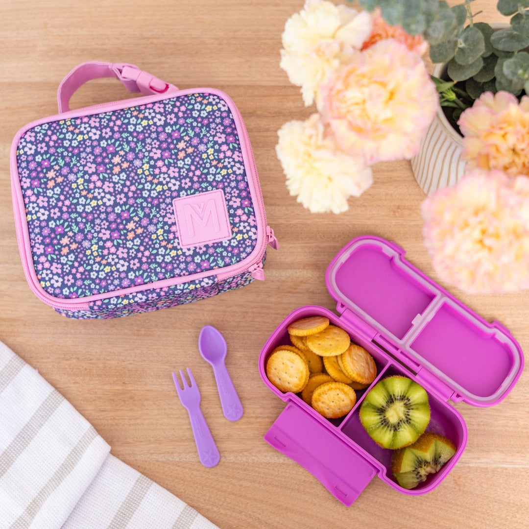 montiico mini meadow lunch bag shown beside a pink bento lunch box to highlight size and use