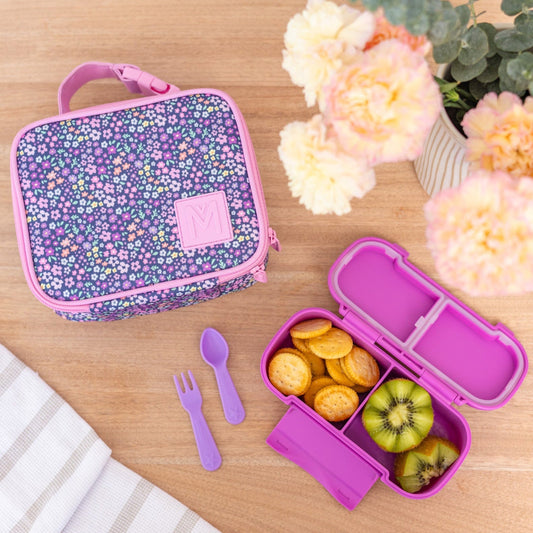 montiico mini meadow lunch bag shown beside a pink bento lunch box to highlight size and use