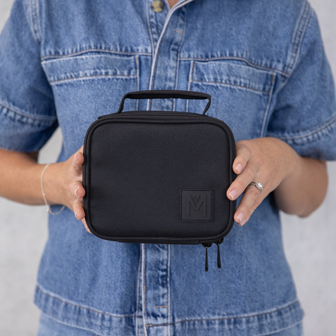 montiico mini midnight lunch bag opened to show bright blue insulated interior and storage space