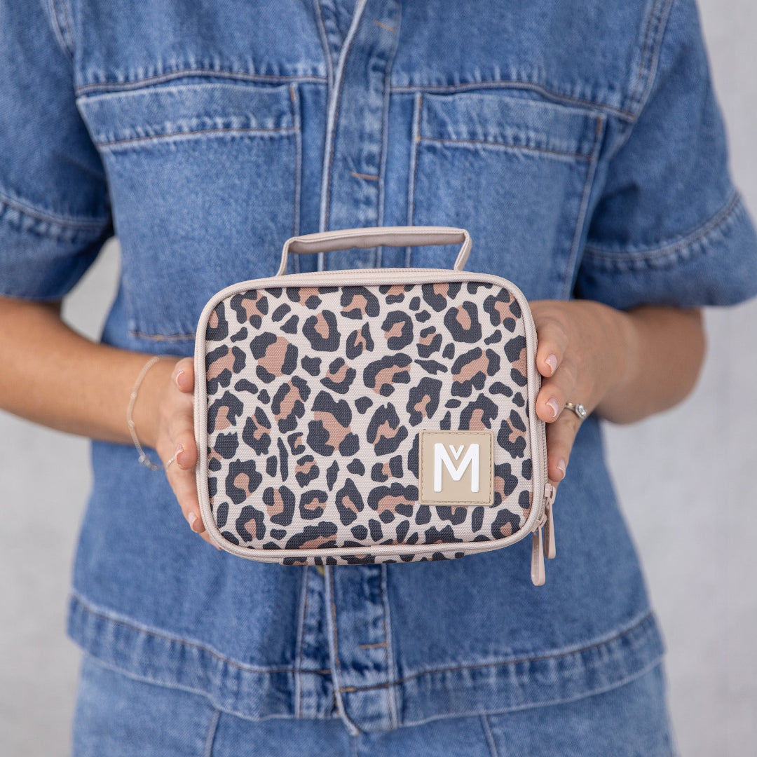 montiico mini safari lunch bag shown being held to demonstrate size and portability