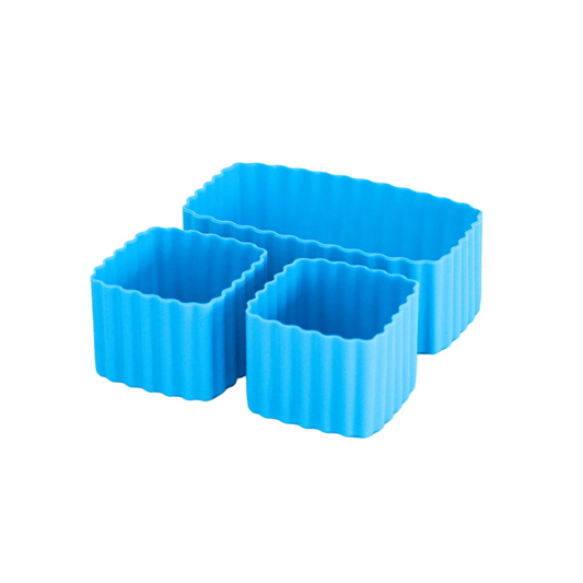 Set of coastal blue MontiiCo mixed bento cups with fluted sides, shown in multiple sizes for organising snacks in lunch boxes."