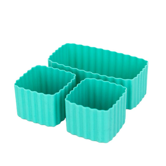 Set of turquoise lagoon MontiiCo mixed bento cups with fluted sides, shown in multiple sizes for organising snacks in lunch boxes.