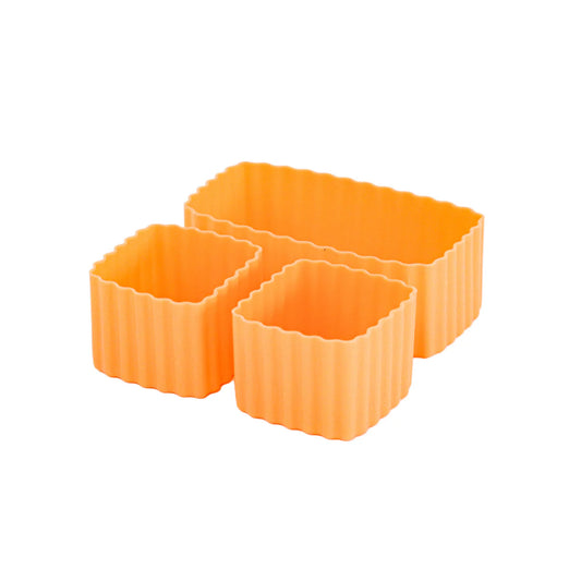 Three orange silicone bento containers with textured sides on a white background