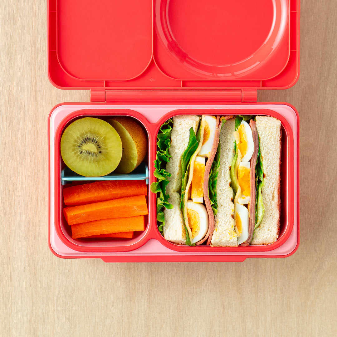 Cherry Pink OmieBox Up bento lunch box with deep compartments holding pasta, vegetables and fruit as a grown up lunch container