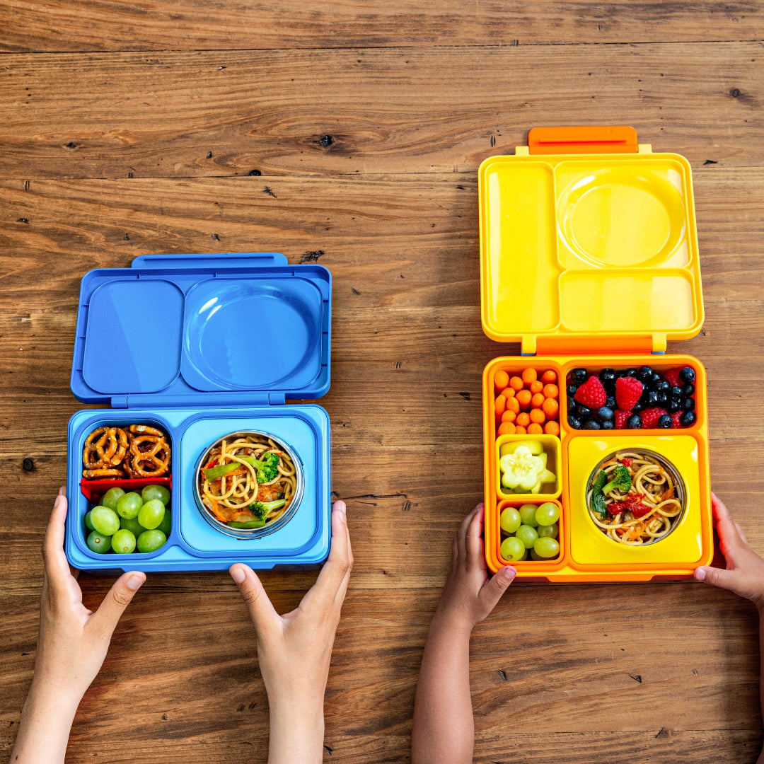 Cosmic Blue OmieBox Up hot and cold bento box filled with wraps, vegetables and fruit in deep compartments.