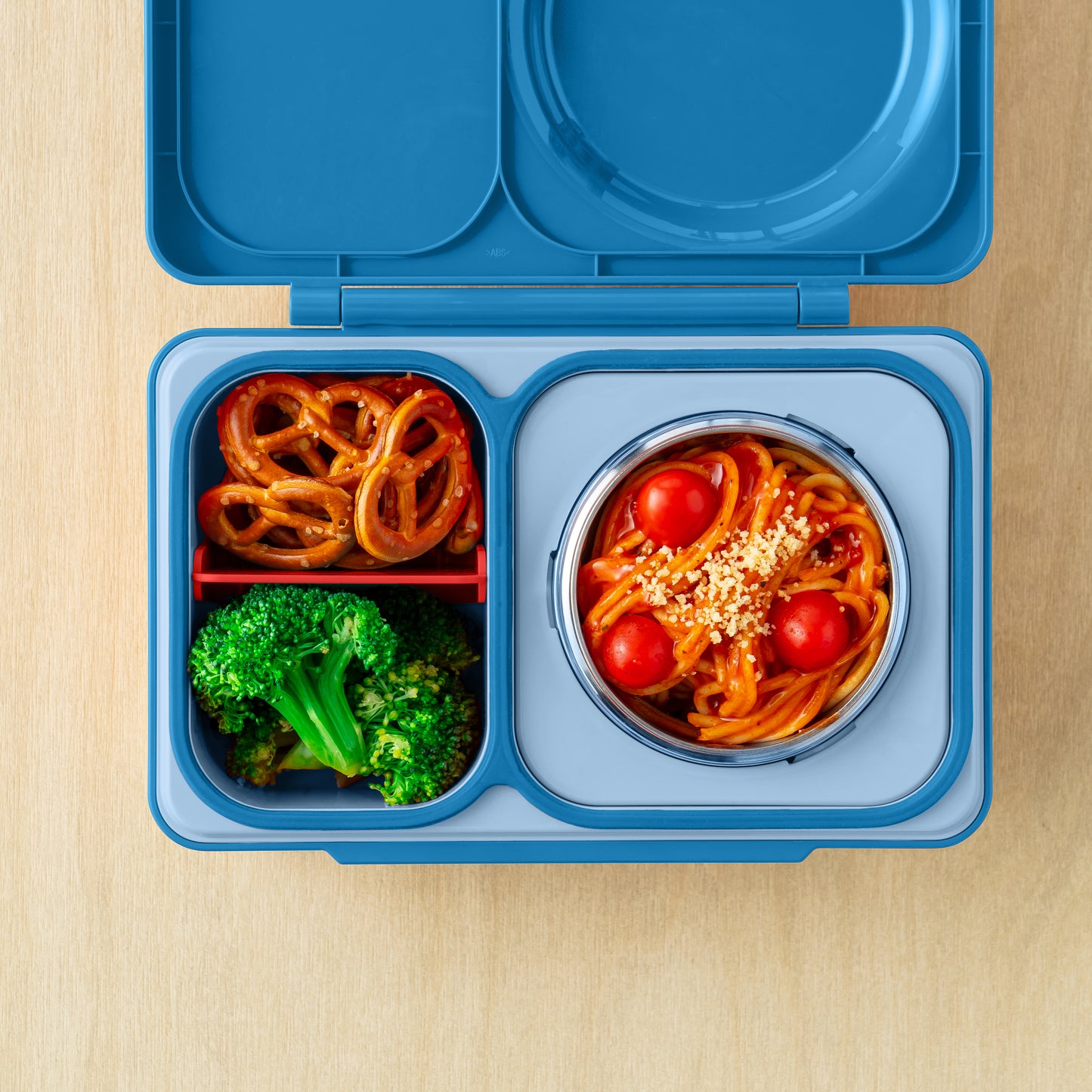Cosmic Blue OmieBox Up bento lunch box with deep compartments holding pasta, vegetables and fruit as a grown up lunch container.
