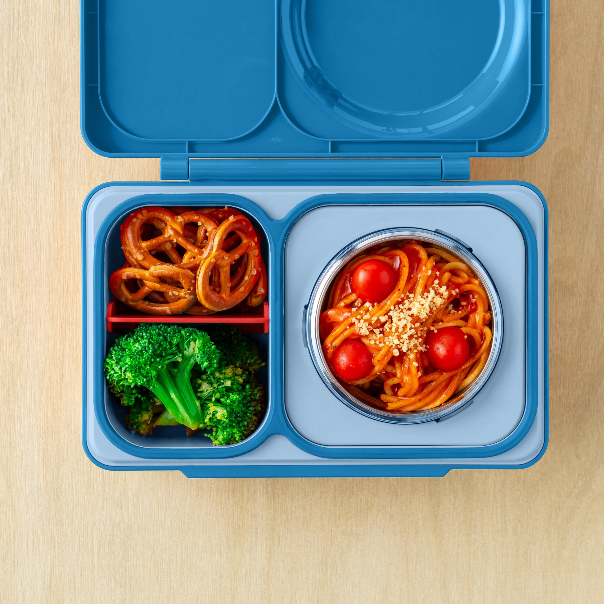 Cosmic Blue OmieBox Up bento lunch box with deep compartments holding pasta, vegetables and fruit as a grown up lunch container.