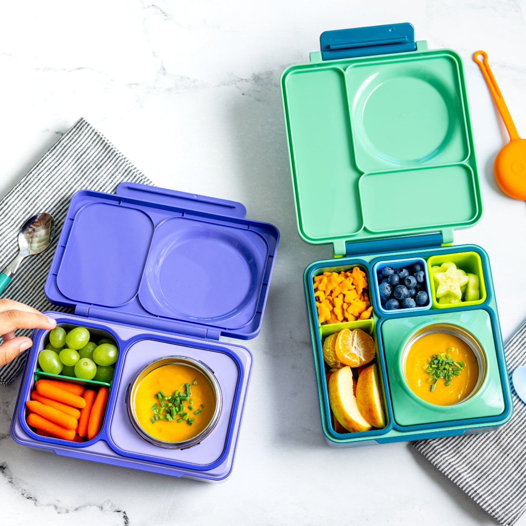 Person using the Graphite OmieBox Up hot and cold bento box as a practical grown up lunch container.