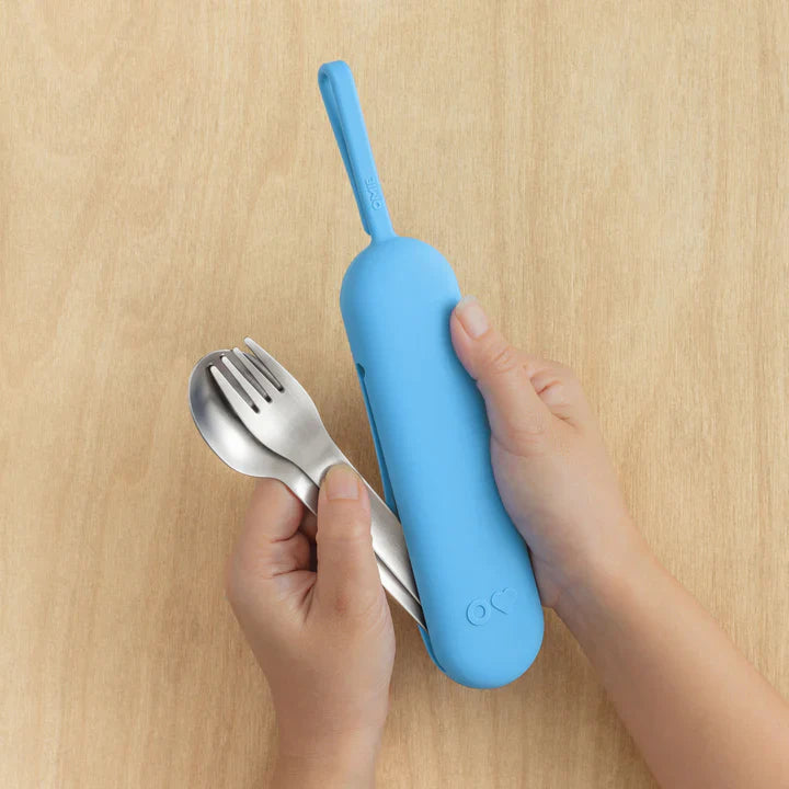 Blue OmieBox Up cutlery pod held in hand showing compact bento cutlery design.