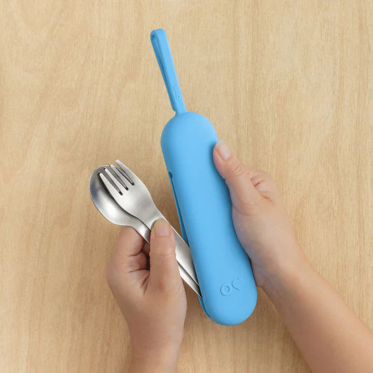 Blue OmieBox Up cutlery pod held in hand showing compact bento cutlery design.