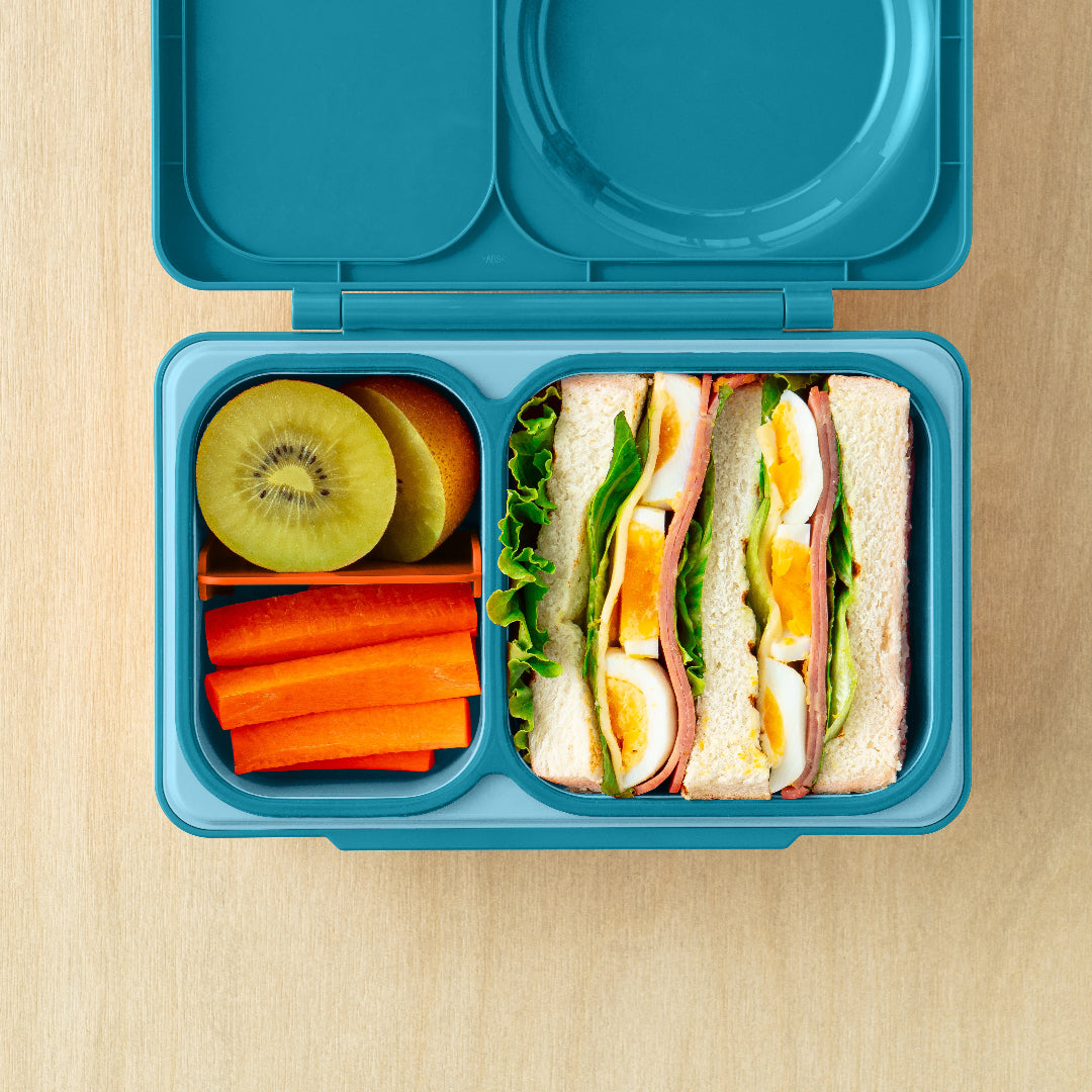 Teal Green OmieBox Up hot and cold bento box filled with wraps, vegetables and fruit in deep compartments