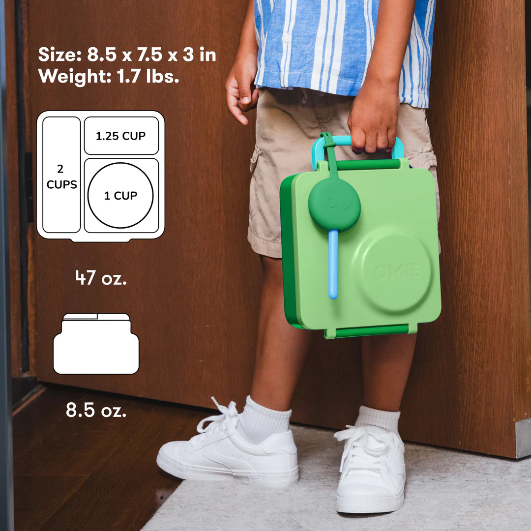 Child carrying the Apple Green OmieBox V2 leakproof bento lunch box, a popular choice in Australia.