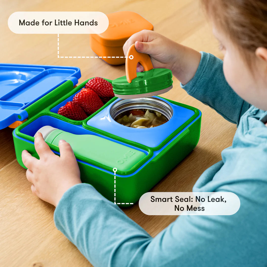 Preparing food in the Monster Blue OmieBox V2 leakproof bento lunch box with divided compartments
