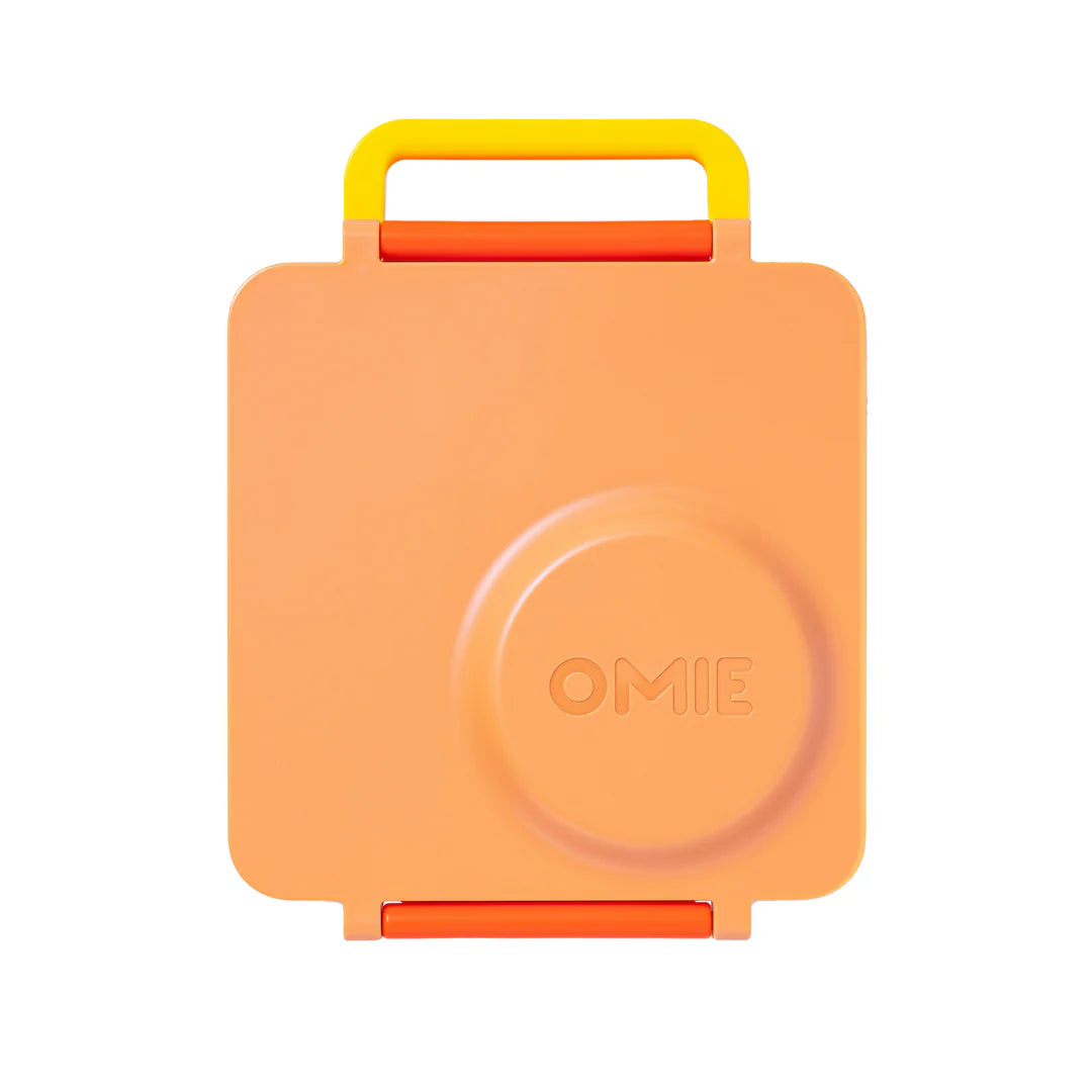 Poppy Orange OmieBox V2 leakproof bento lunch box shown closed with carry handle.