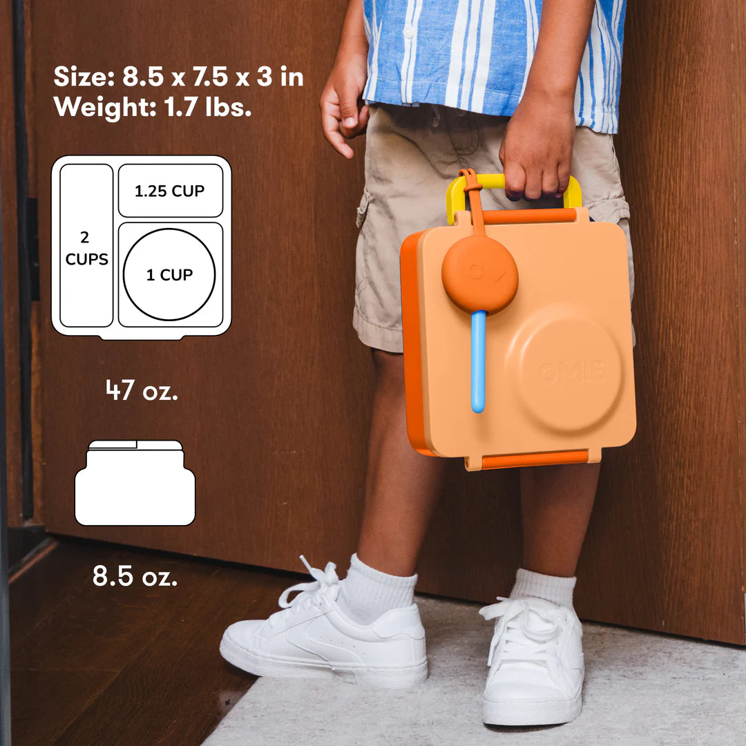 Child carrying the Poppy Orange OmieBox V2 leakproof bento lunch box, popular in Australia