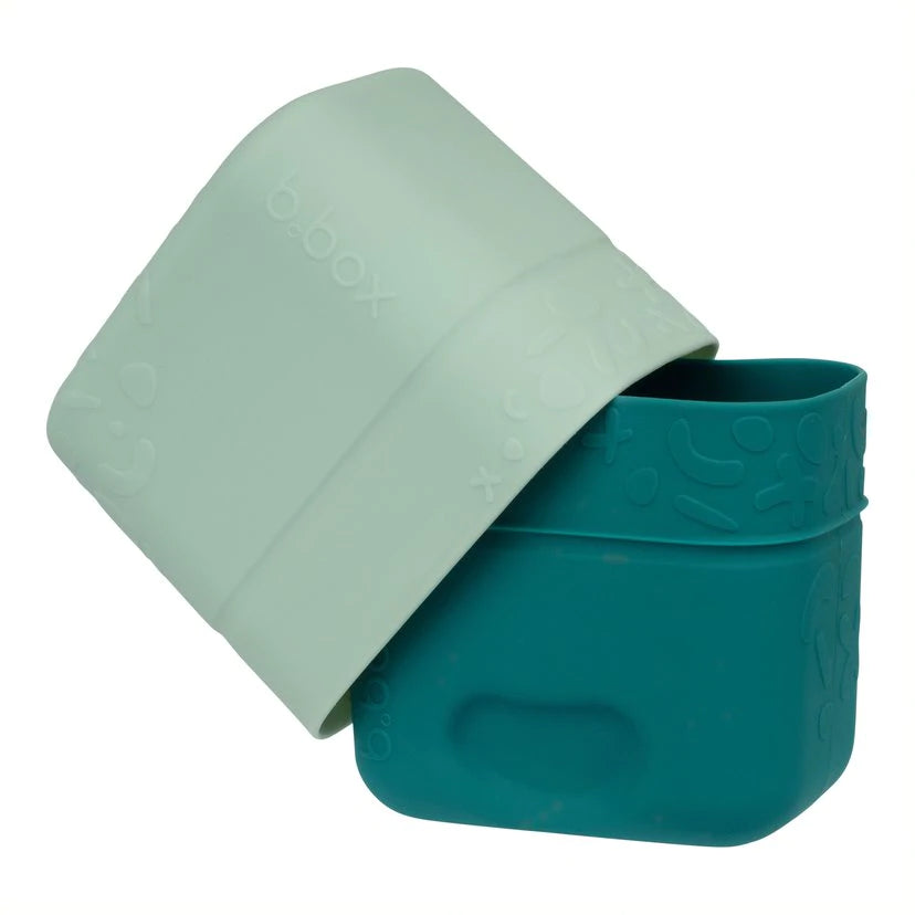 Stacked Forest green b.box snack cups highlighting soft, flexible silicone.