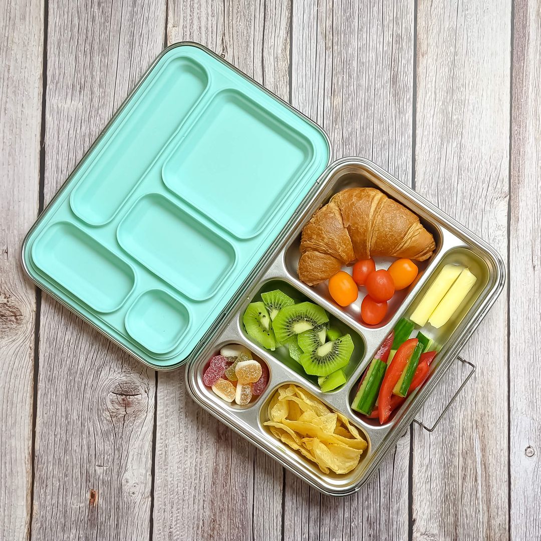 Ecococoon leakproof bento box with five compartments and silicone mint‑green lid, shown filled with food to highlight its durable metal lunch box design.