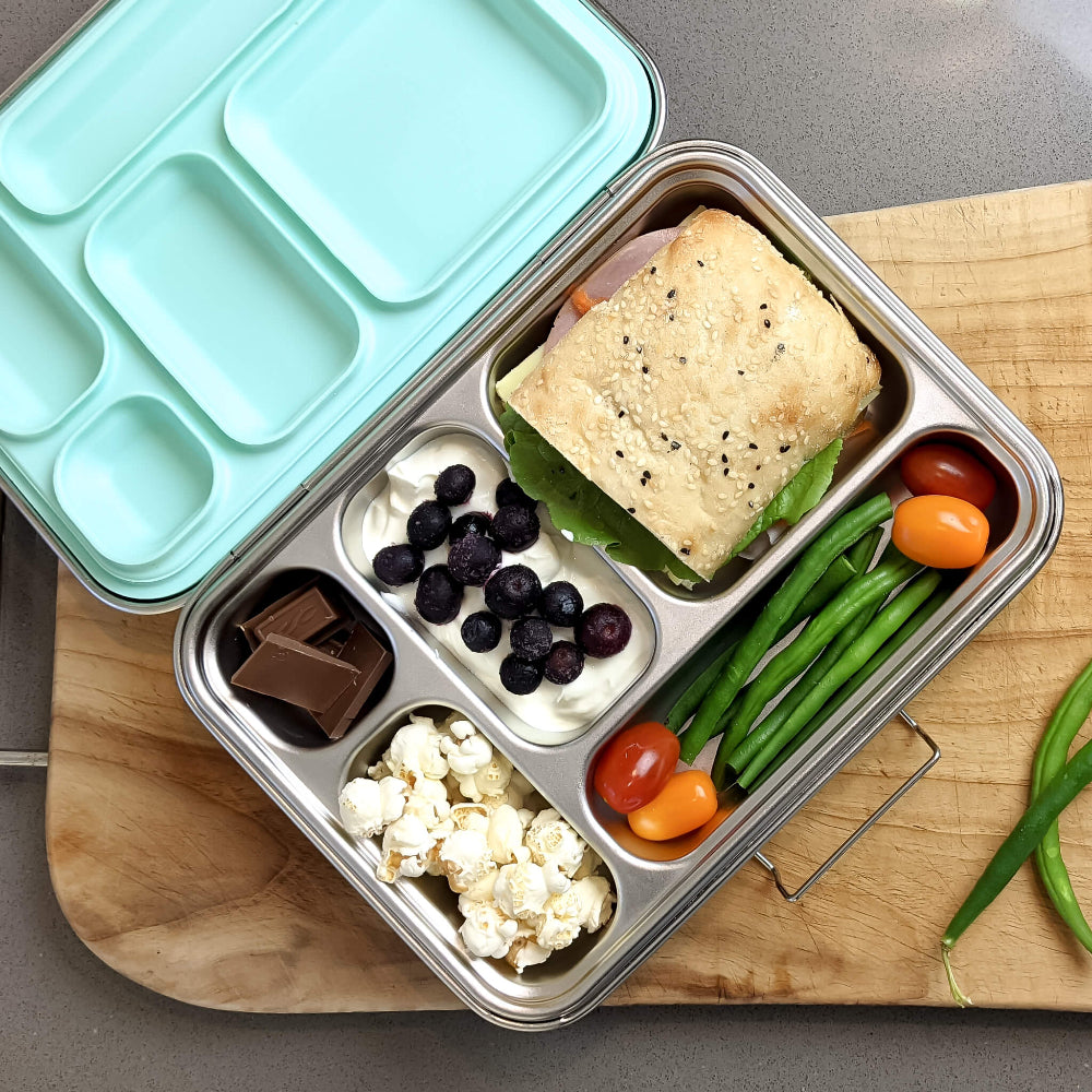 Ecococoon stainless steel leakproof bento box with five compartments and mint‑green lid, shown filled with food to highlight its durable metal lunch box design.