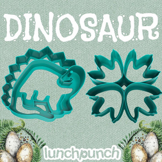 Lunch Punch Dinosaur sandwich cutter set with two teal dinosaur shapes on a green background