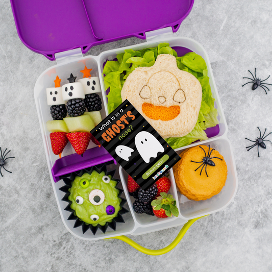 Halloween‑themed sandwiches shaped like pumpkins and spiderwebs made using the Lunch Punch Halloween cutters