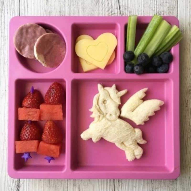 Unicorn‑themed lunchbox with sandwiches and snacks cut using the Lunch Punch Unicorn cutters