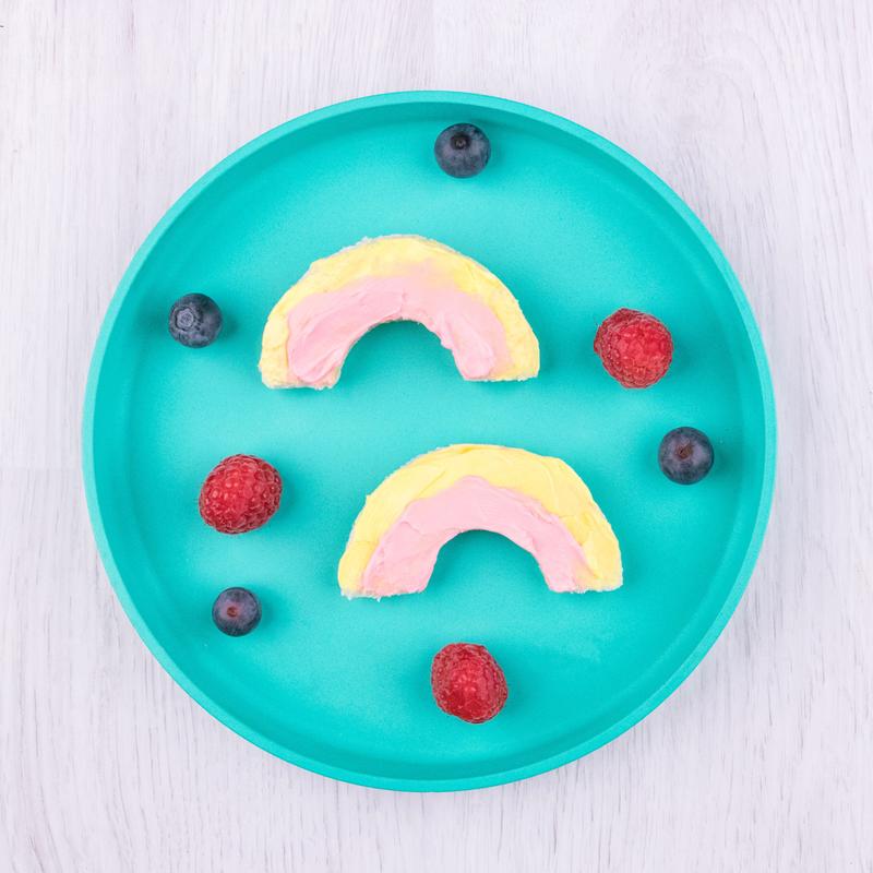 Rainbow‑shaped Mini Bites pieces arranged on a plate with decorative dots