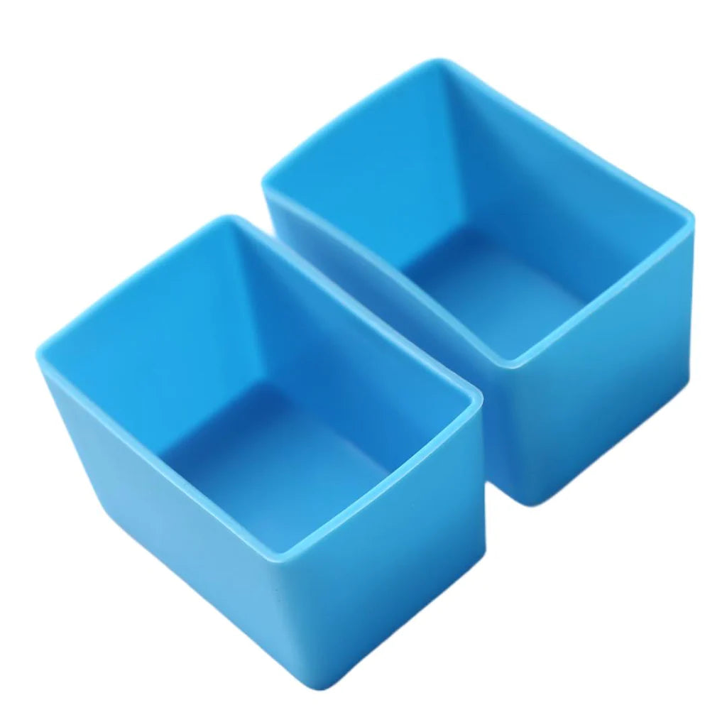 Two blue silicone rectangle cups designed for use with a bento box lunch set.