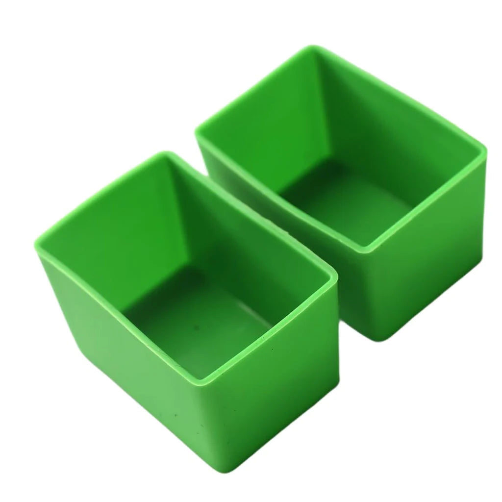 Two green rectangular silicone Munch Cups placed side by side against a white background.